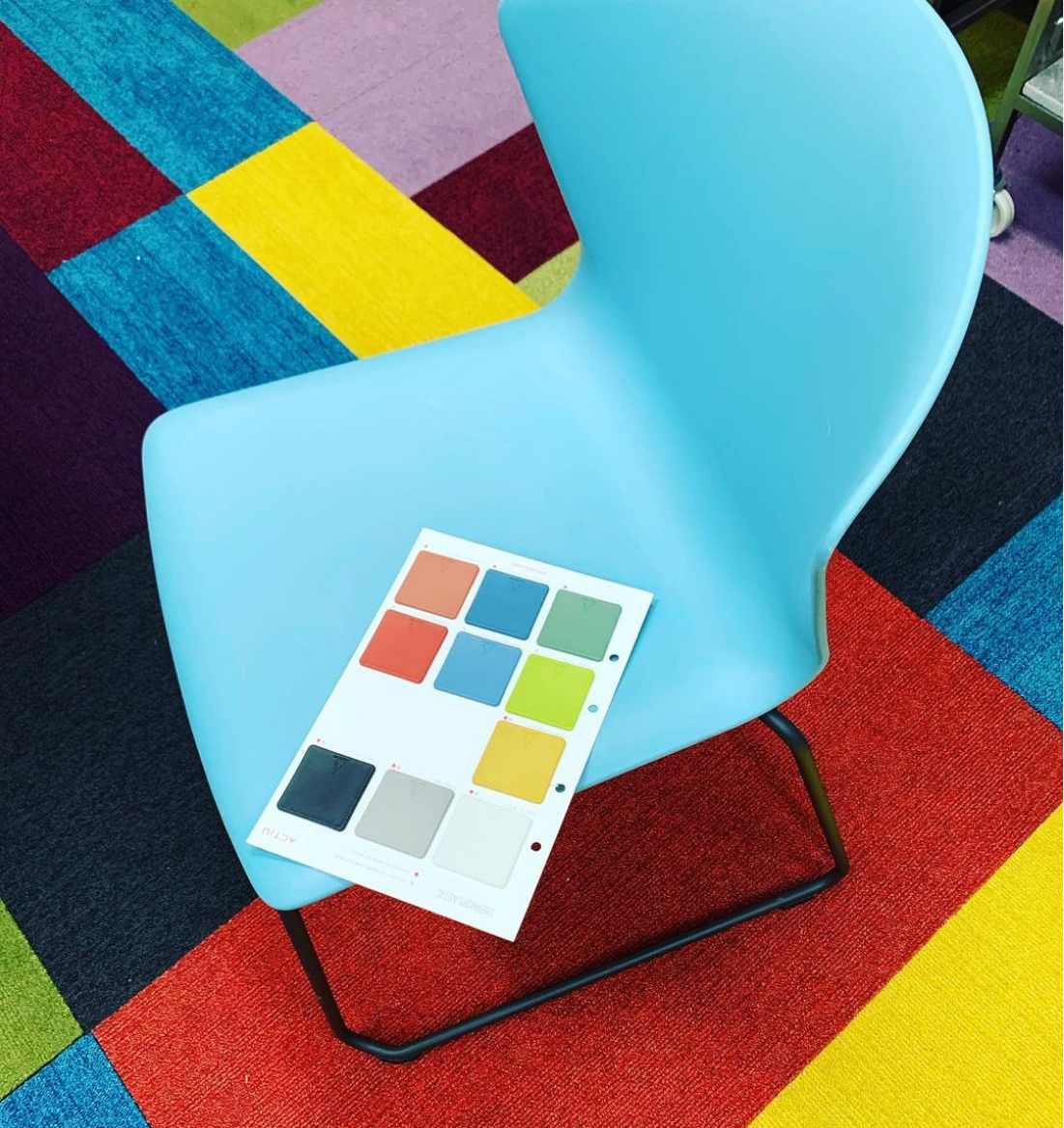 a blue chair with a colour card on it
